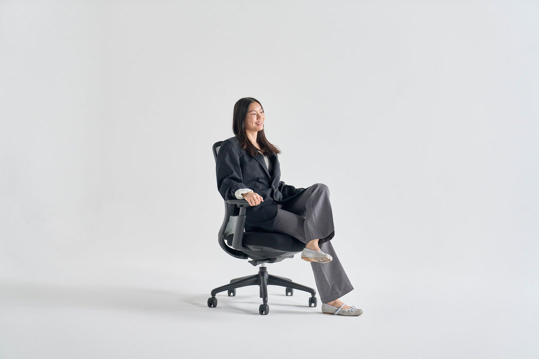 Ergonomic task chairs including HAG Capisco and Herman Miller Aeron at height-adjustable desks in a modern Australian office - Chair Dinkum