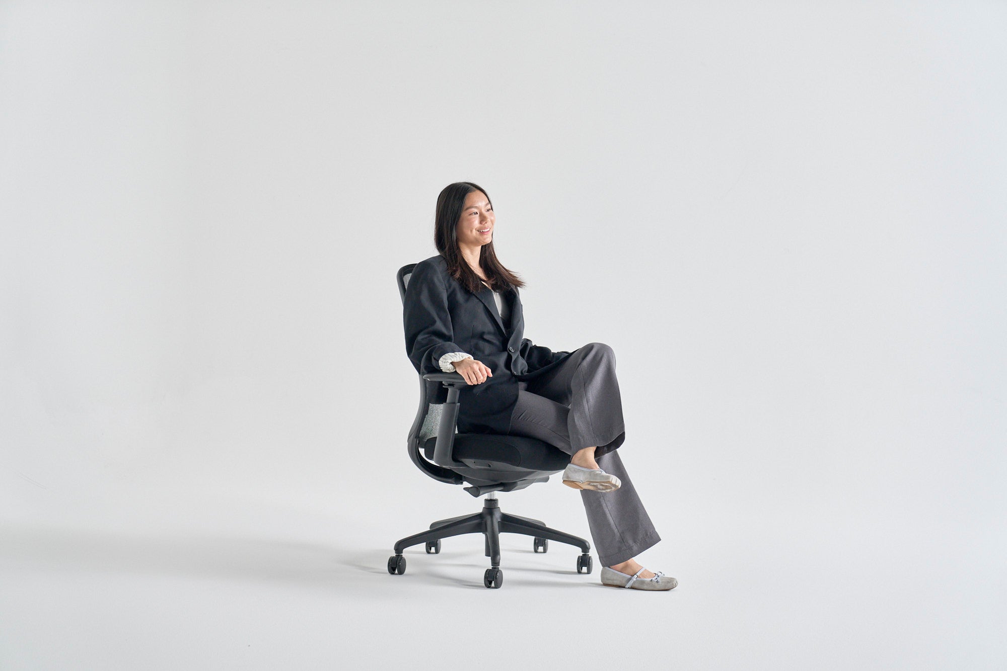 Ergonomic task chairs including HAG Capisco and Herman Miller Aeron at height-adjustable desks in a modern Australian office - Chair Dinkum