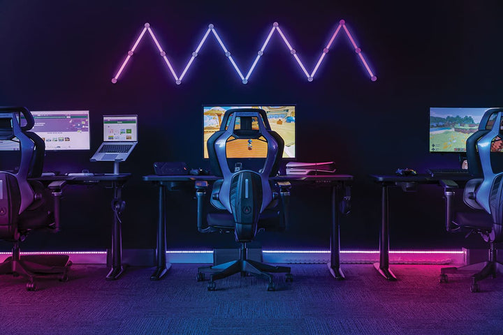 Row of Buro x PowerA Frontier gaming desks with LED lighting in an esports room