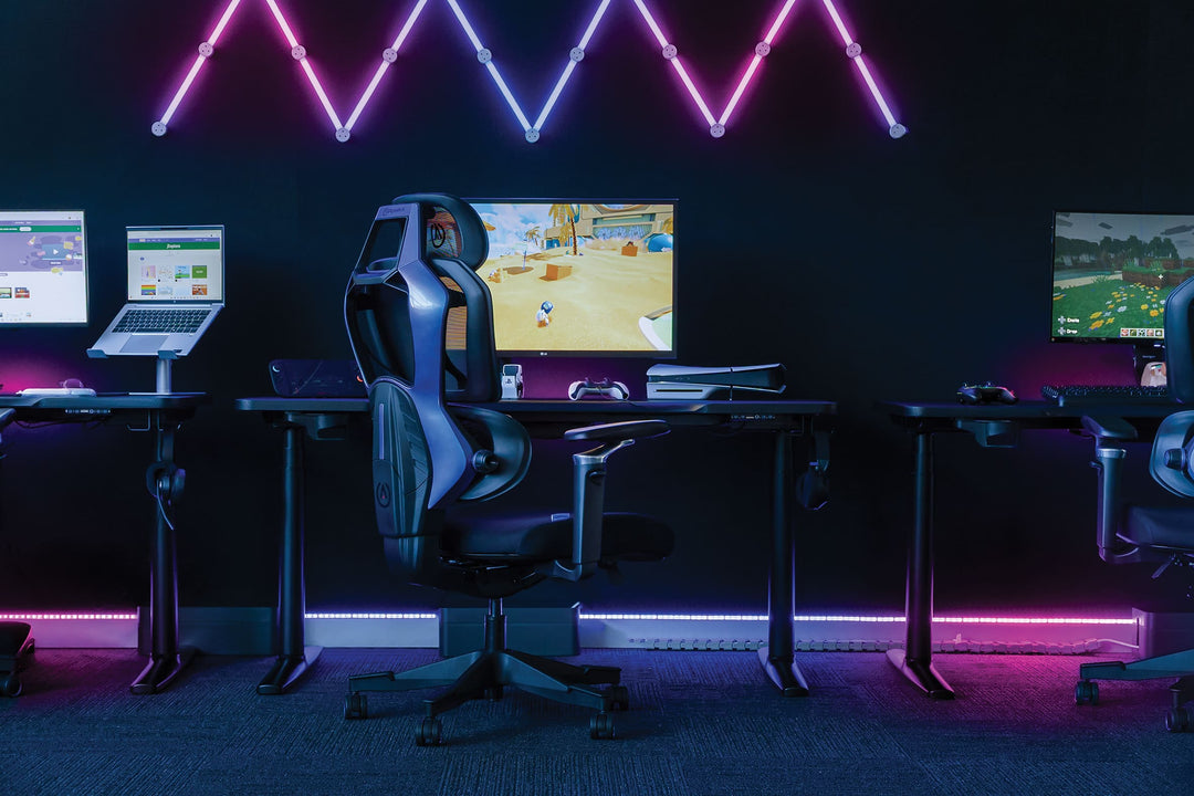 Buro x PowerA Frontier gaming desks with LED lighting and gaming chairs in a gaming room
