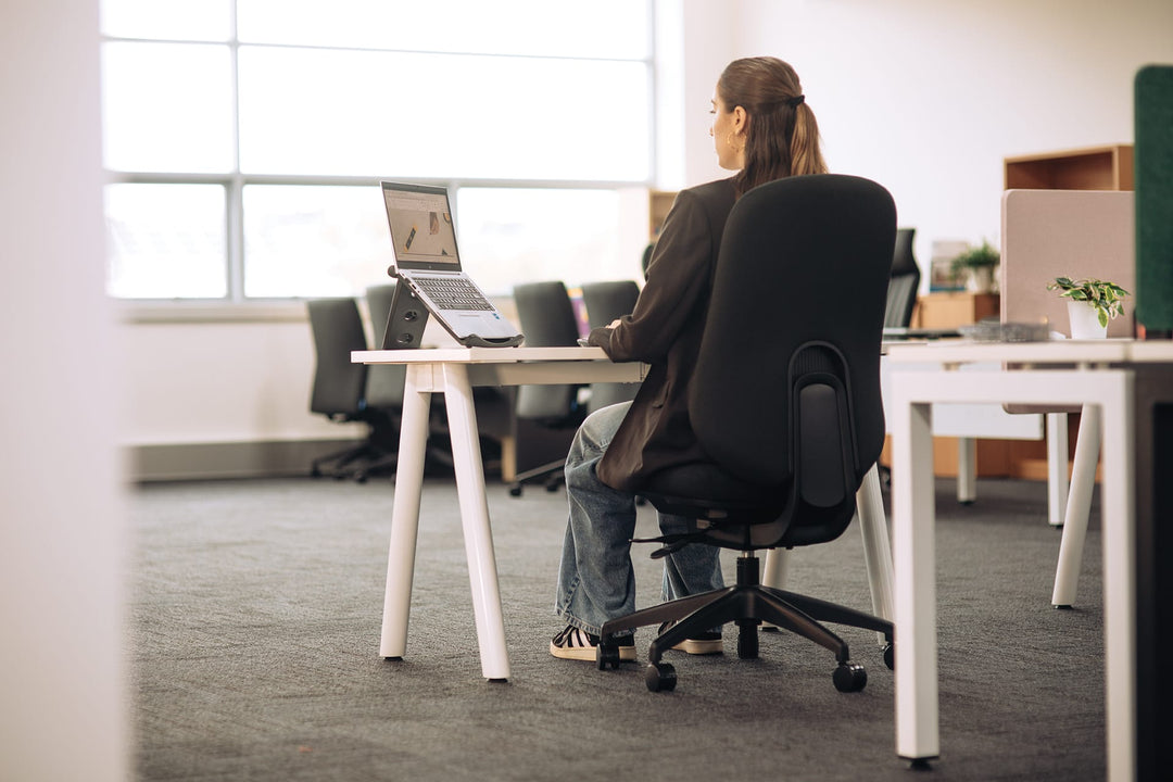 Woman working at a laptop on a Buro Quantum upholstered office chair