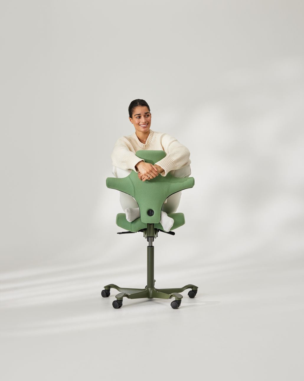 Person demonstrating ergonomic sitting posture on HAG Capisco chair - Chair Dinkum Australia