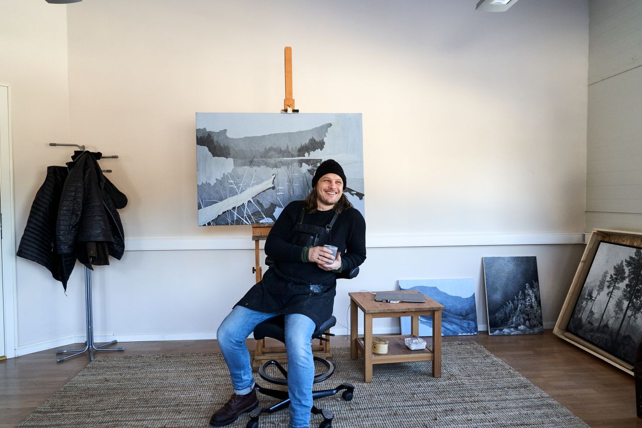 Artist sitting on HAG Capisco chair in painting studio - Chair Dinkum Australia