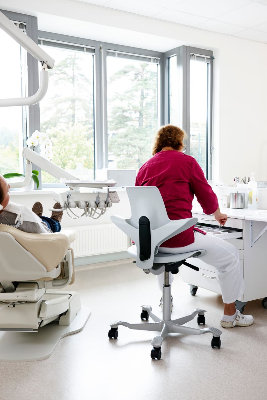 Dentist leaning forward on HAG Capisco
