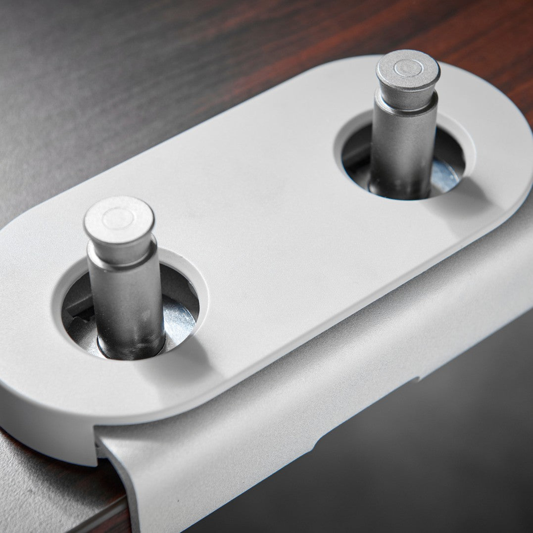 CBS Flo Dual dual-mount clamp in silver with its cover, holding the posts of both arms at the desk edge - Chair Dinkum Australia