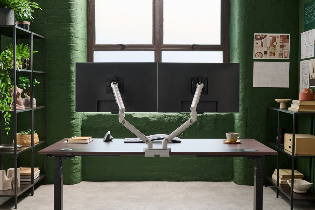 CBS Flo Dual in silver holding two screens side by side on a desk in a green-walled office - Chair Dinkum Australia