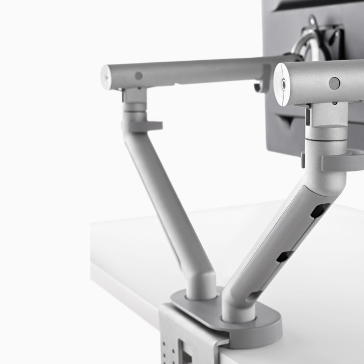 CBS Flo Dual arms in silver forming a V from one dual clamp and cover, behind two screens - Chair Dinkum Australia