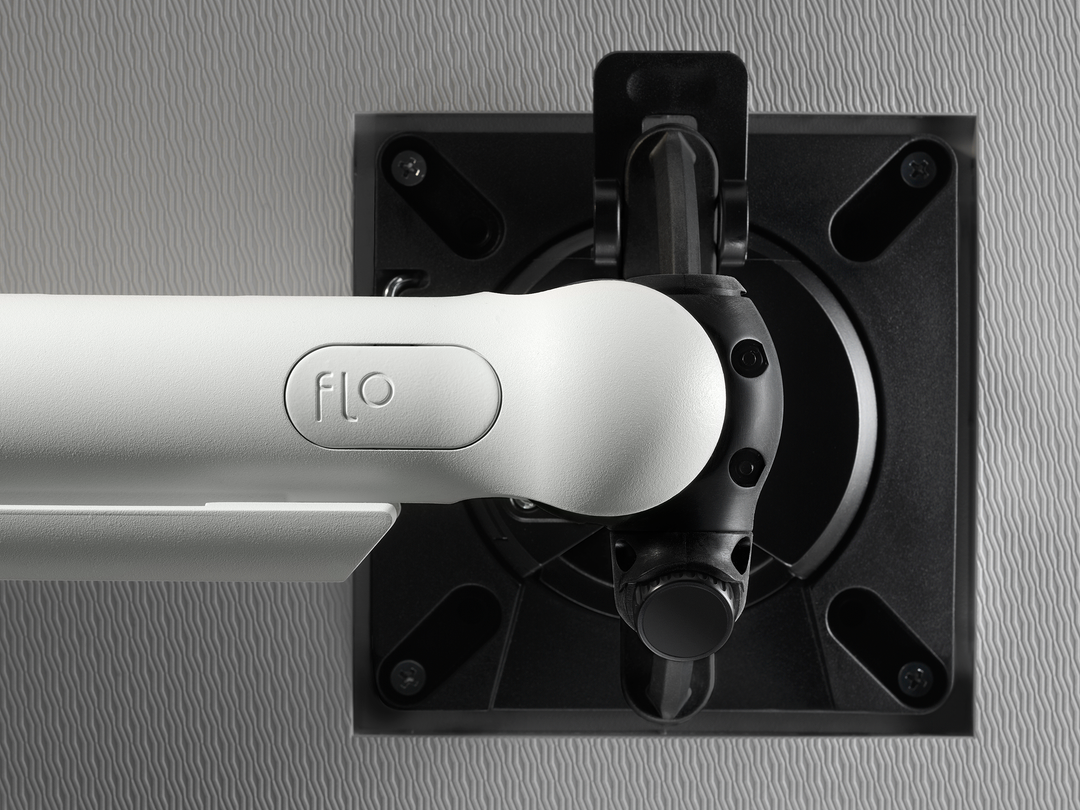 Close-up of the VESA head and portrait-to-landscape rotation on a white CBS Flo monitor arm (Colebrook Bosson Saunders photograph)