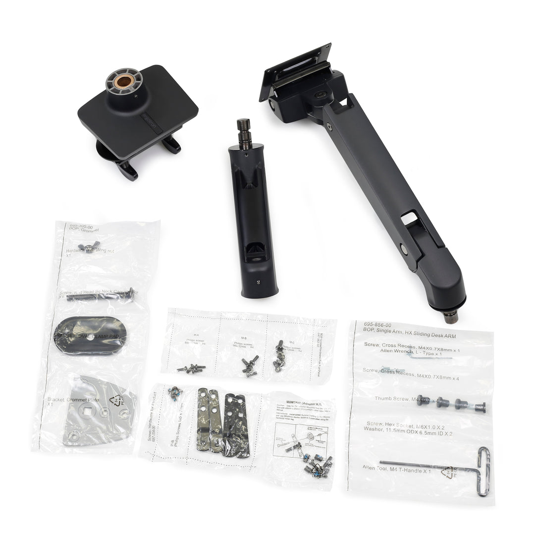 The parts of a matte black Ergotron HX Desk Monitor Arm laid out with its hardware