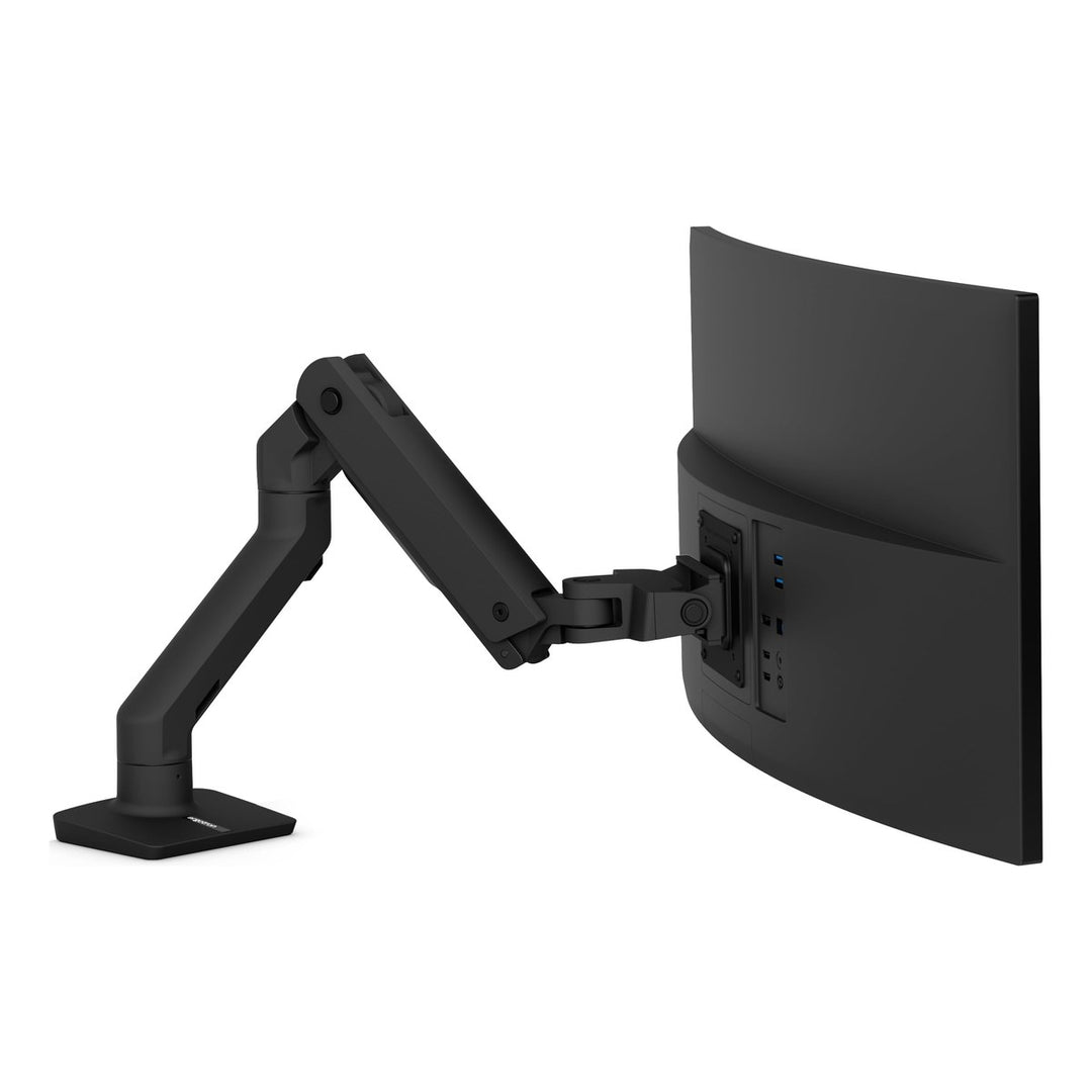 Ergotron HX Desk Monitor Arm in matte black holding a large curved screen, rear three-quarter view