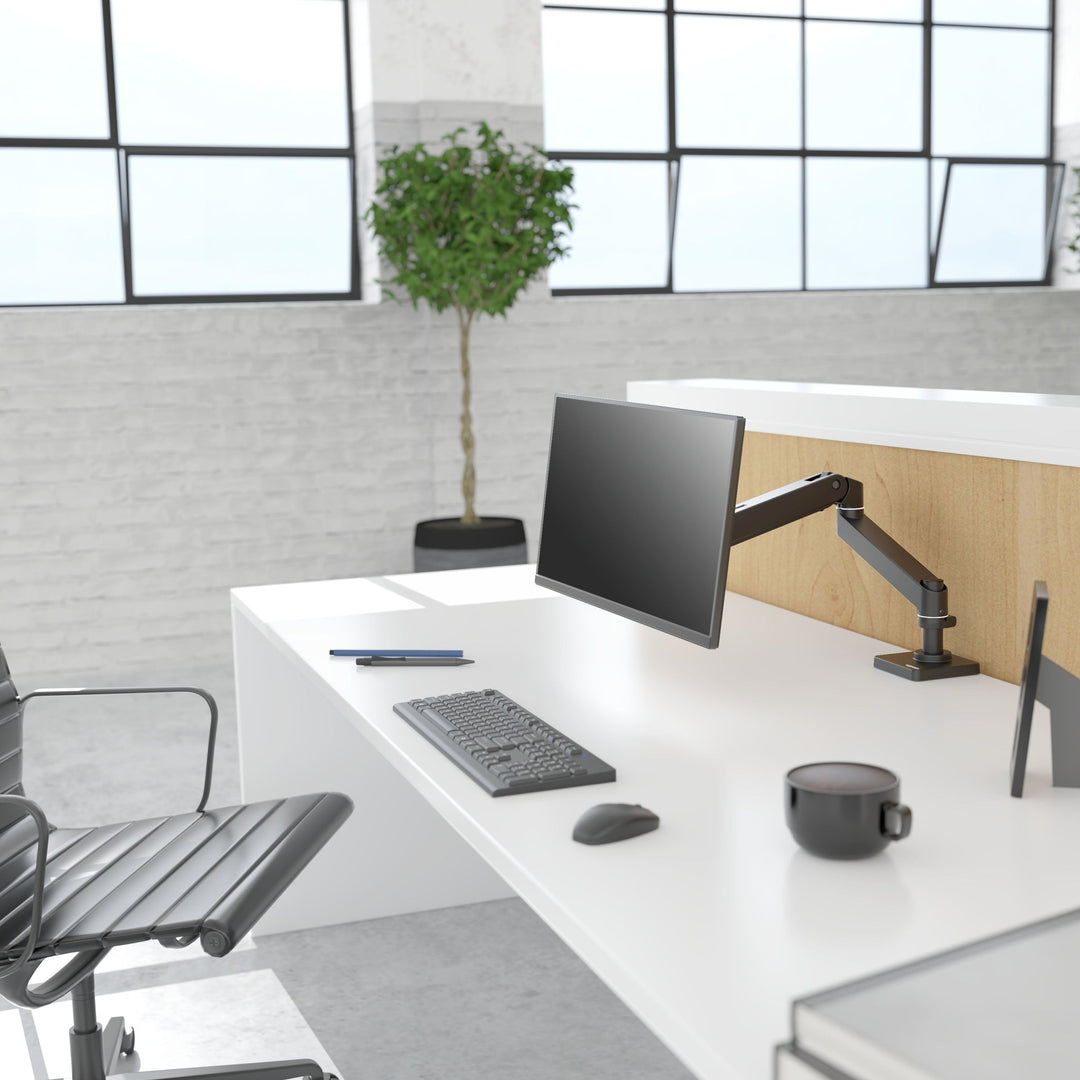 Bright office desk with a screen on a matte black Ergotron LX Pro Desk Monitor Arm