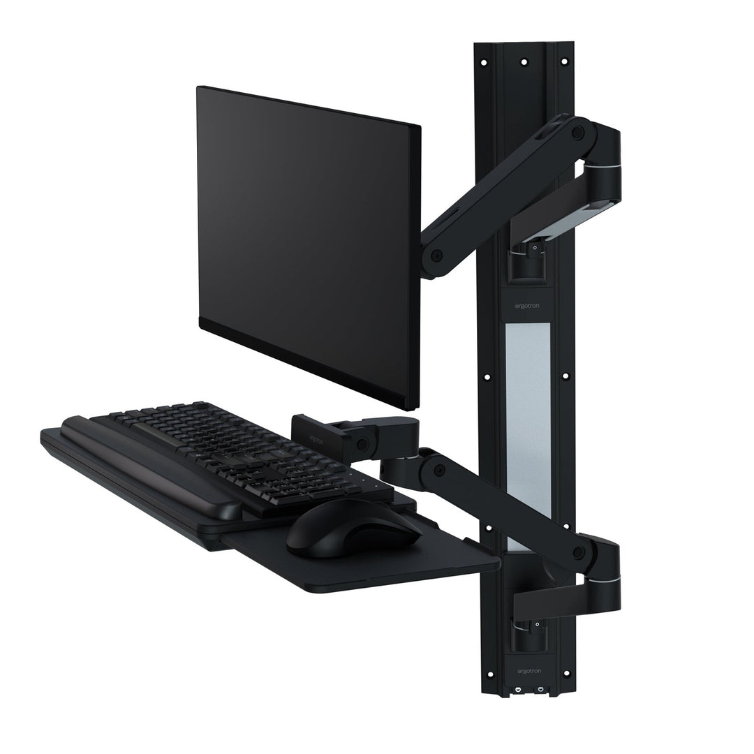Ergotron LX Pro Wall Mount System in black with a screen, keyboard tray and mouse tray on a wall track