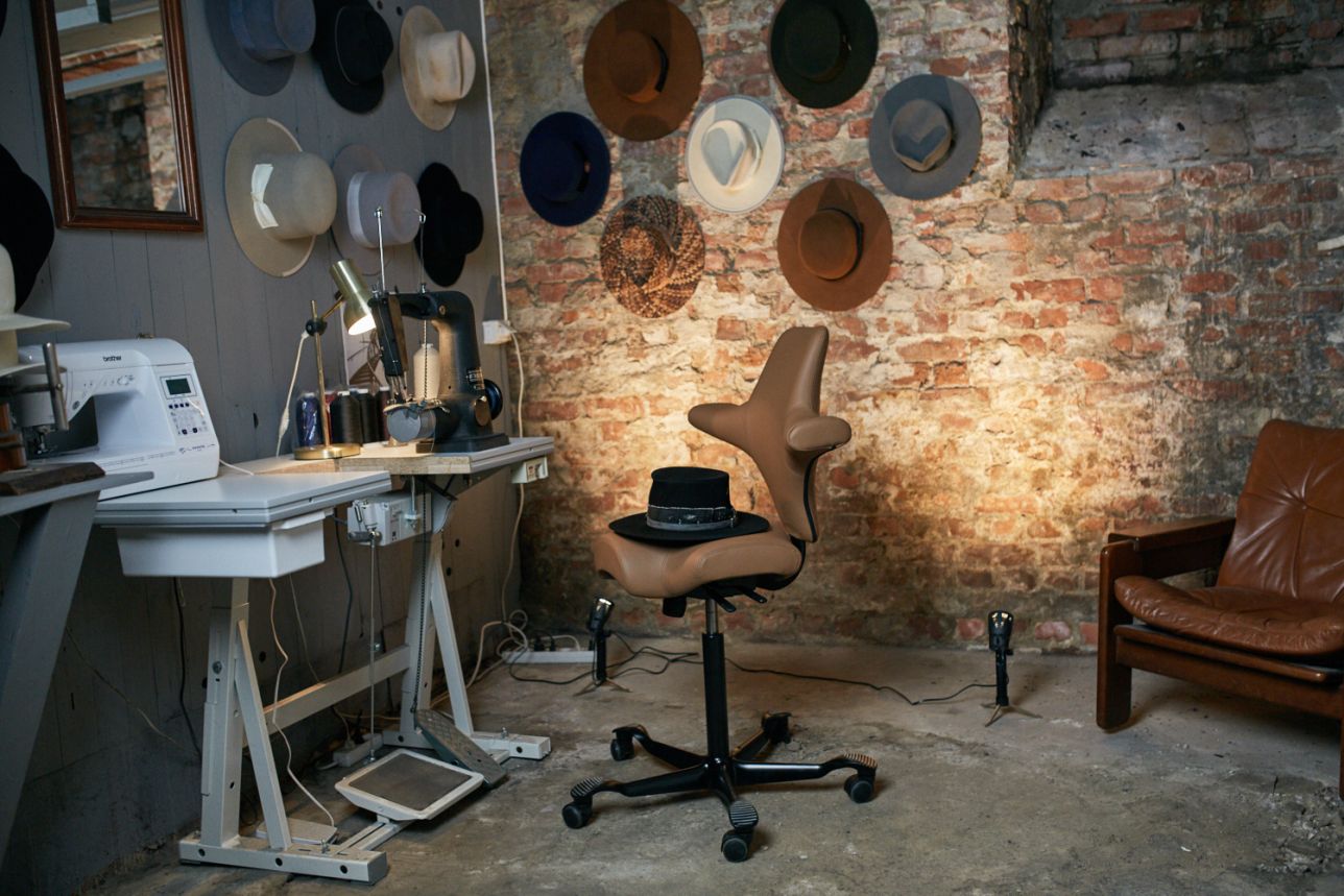 Craftsperson working on HAG Capisco ergonomic chair in workshop - Chair Dinkum Australia