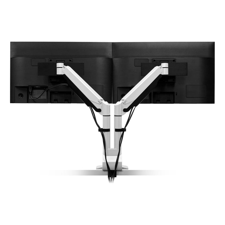 Rear view of a white HAT Collective E2 dual monitor arm with cables routed down the pole