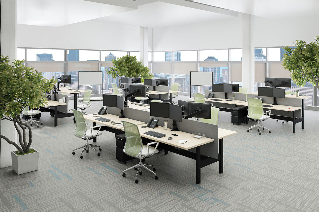 Open-plan benching fitted with black HAT Collective E2 monitor arms