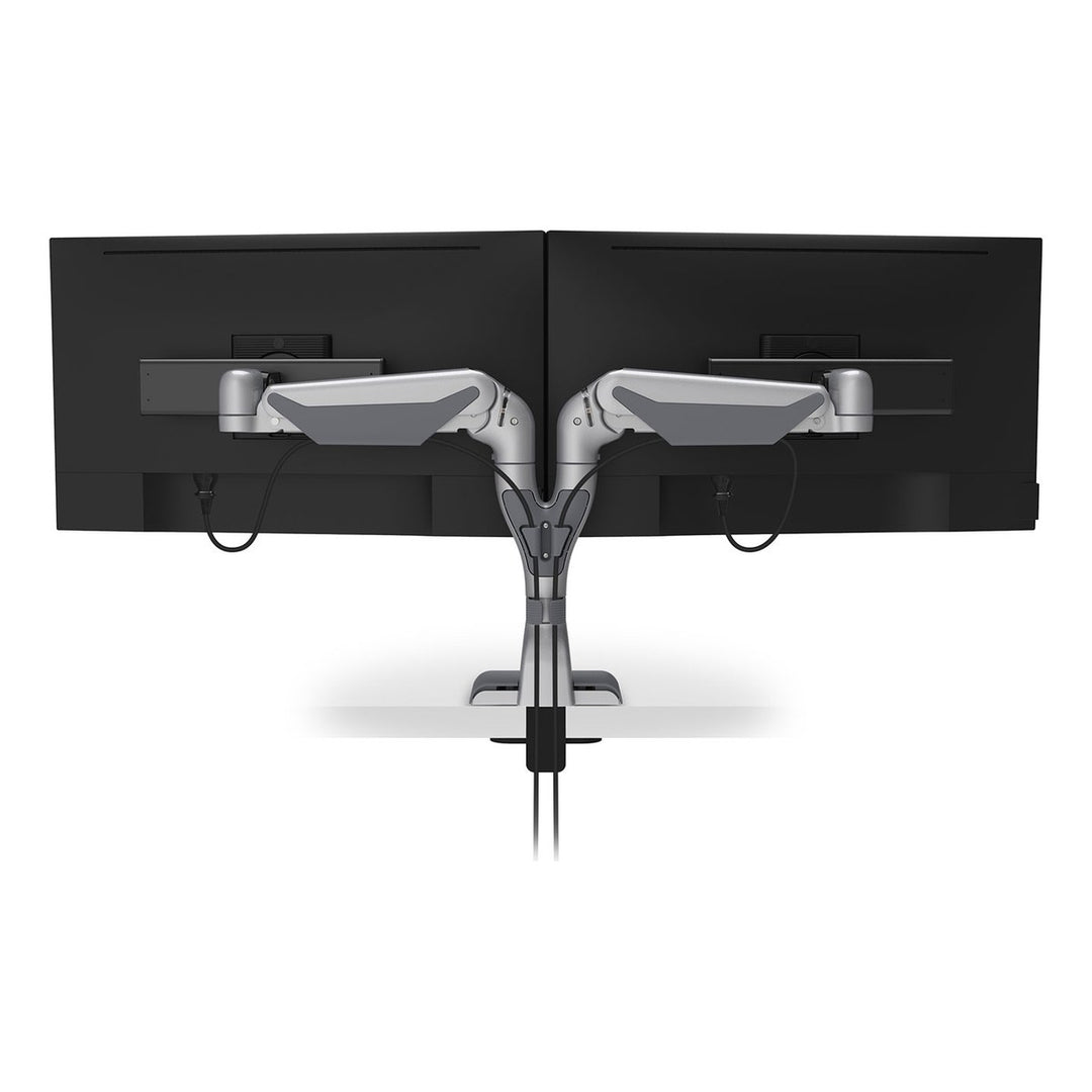 Rear view of a HAT Collective E5 dual dynamic monitor arm in silver with cables routed down the post