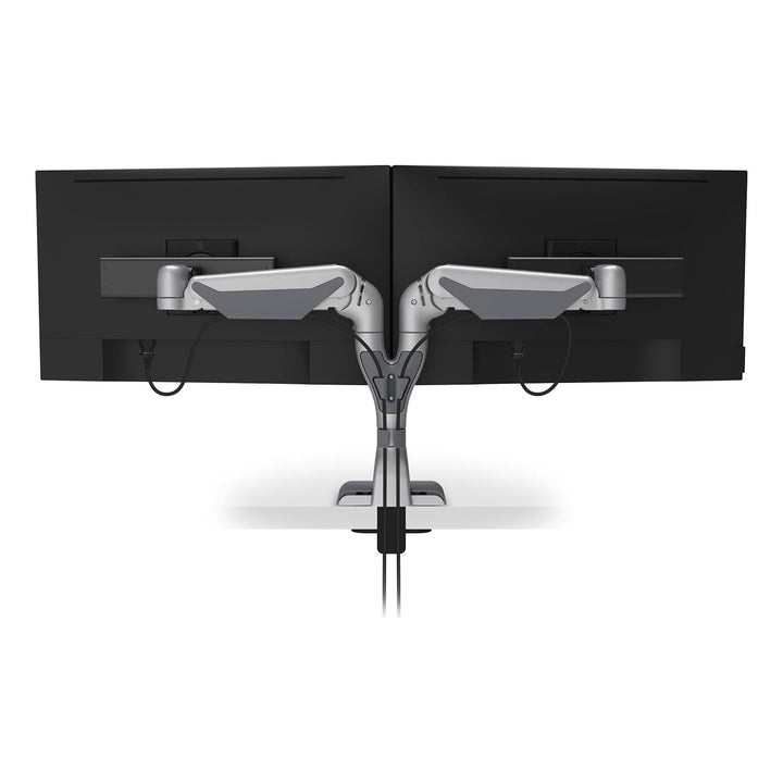 Rear view of a HAT Collective E5 dual dynamic monitor arm in silver with cables routed down the post