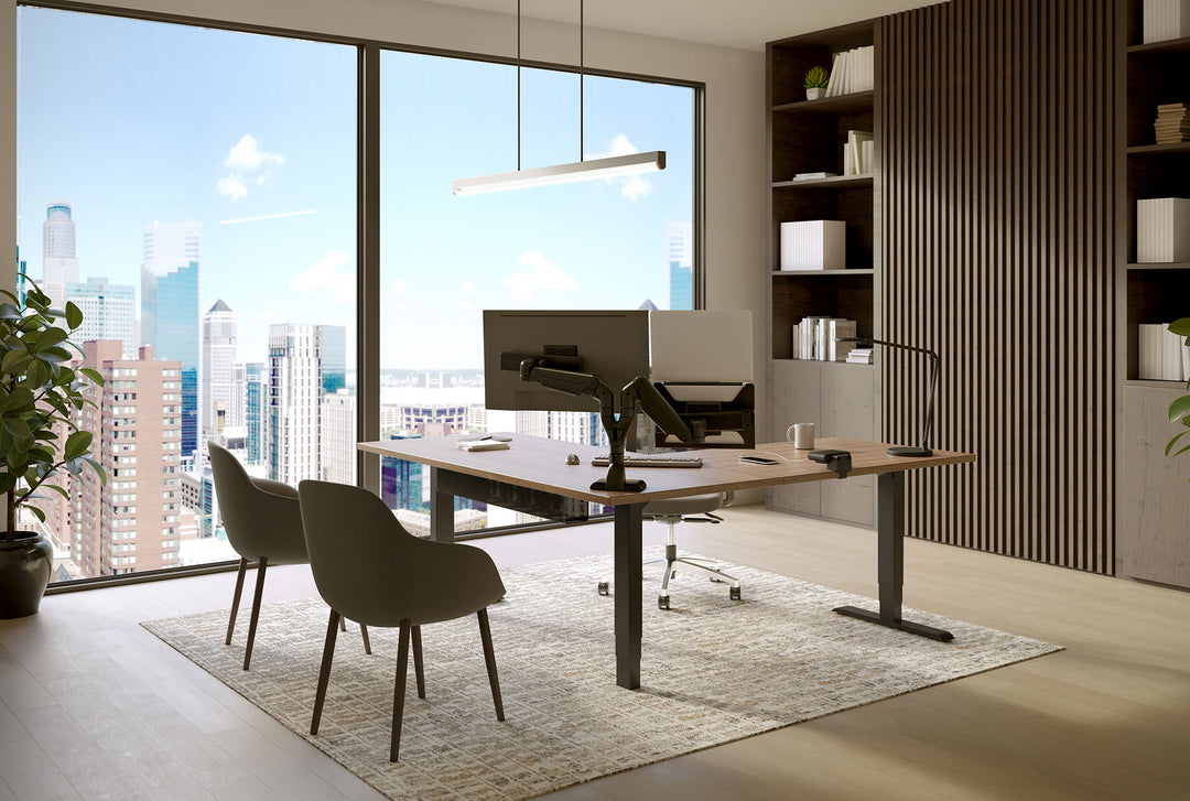 Private office with a black HAT Collective E5 dual monitor arm and laptop holder on an L-shaped height-adjustable desk