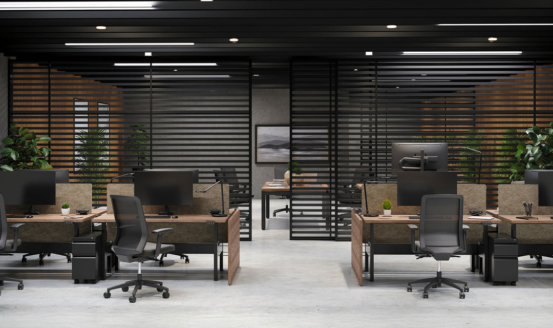 Benching desks in a dark-panelled office fitted with black HAT Collective E5 monitor arms