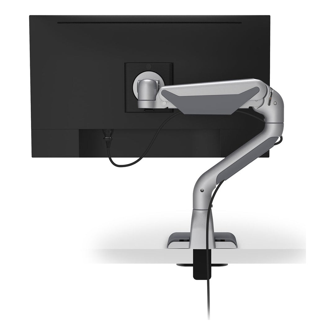 Rear view of a HAT Collective E5 single dynamic monitor arm in silver with cables routed through the arm