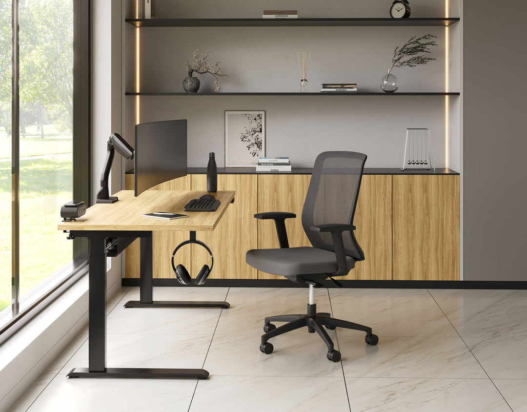 Private office with a black HAT Collective E5 single monitor arm on a height-adjustable desk beside a window
