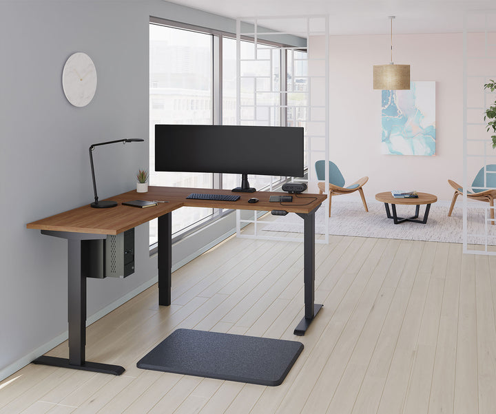 Private office with an ultrawide screen on a black HAT Collective E5 single monitor arm on an L-shaped desk