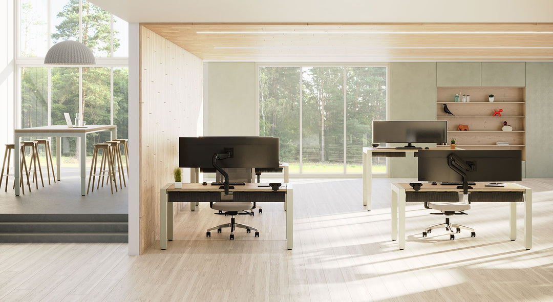 Open office with HAT Collective E5 single monitor arms on desks looking out to a garden