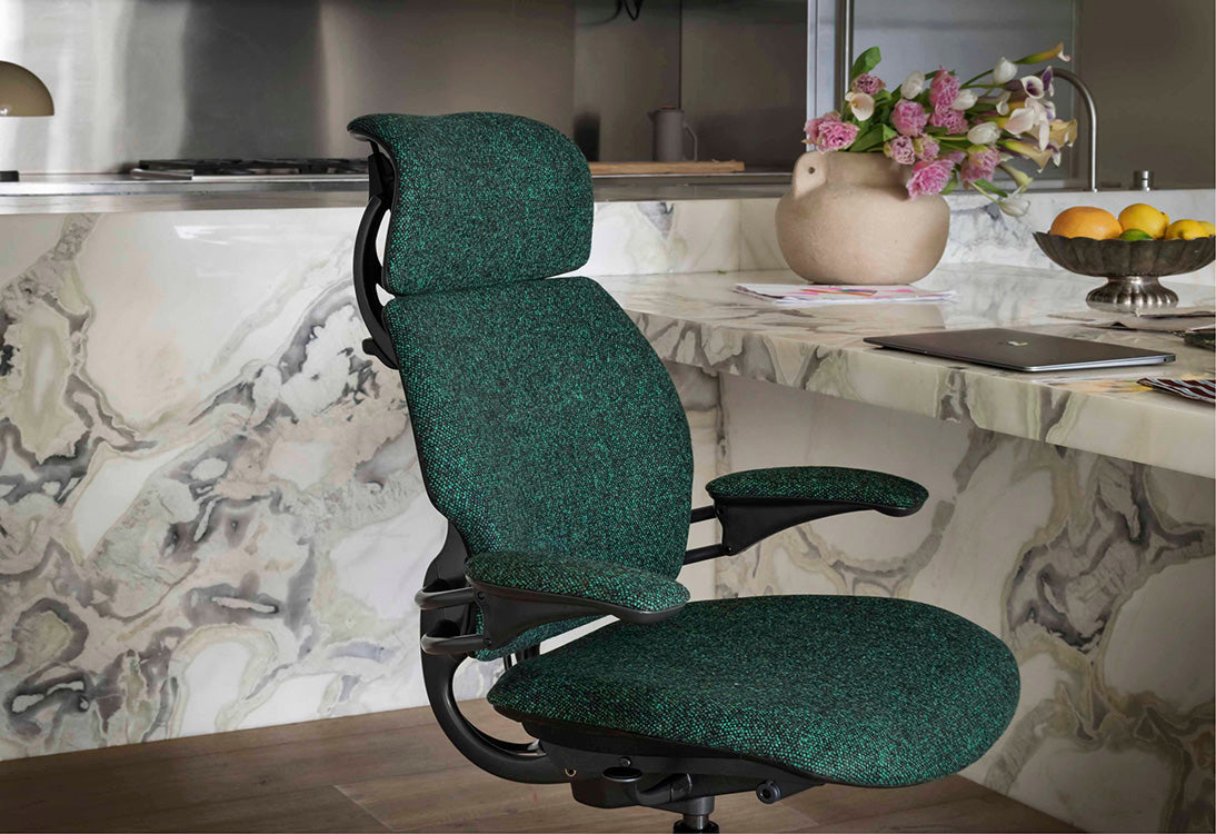 Humanscale Freedom ergonomic chair with headrest in an executive office setting with timber desk, black upholstery - Chair Dinkum Australia