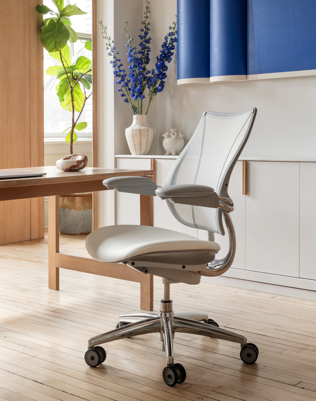 Humanscale Liberty task chair with pale mesh beside a timber desk in a bright home office - Chair Dinkum Australia