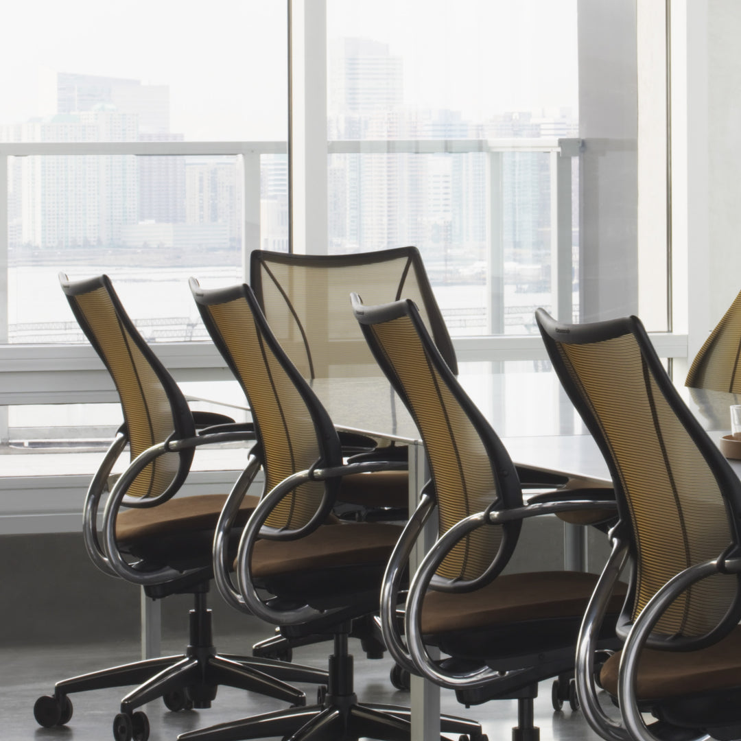 Humanscale Liberty task chairs with gold-tan mesh around a workplace table - Chair Dinkum Australia