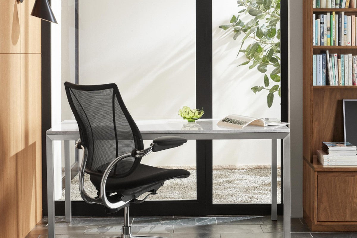 Humanscale Liberty mesh task chair at a desk, showing the tri-panel mesh back