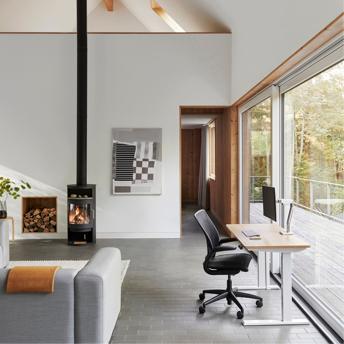 Home workspace with a Humanscale monitor arm, oak sit-stand desk and mesh task chair (Humanscale photograph)