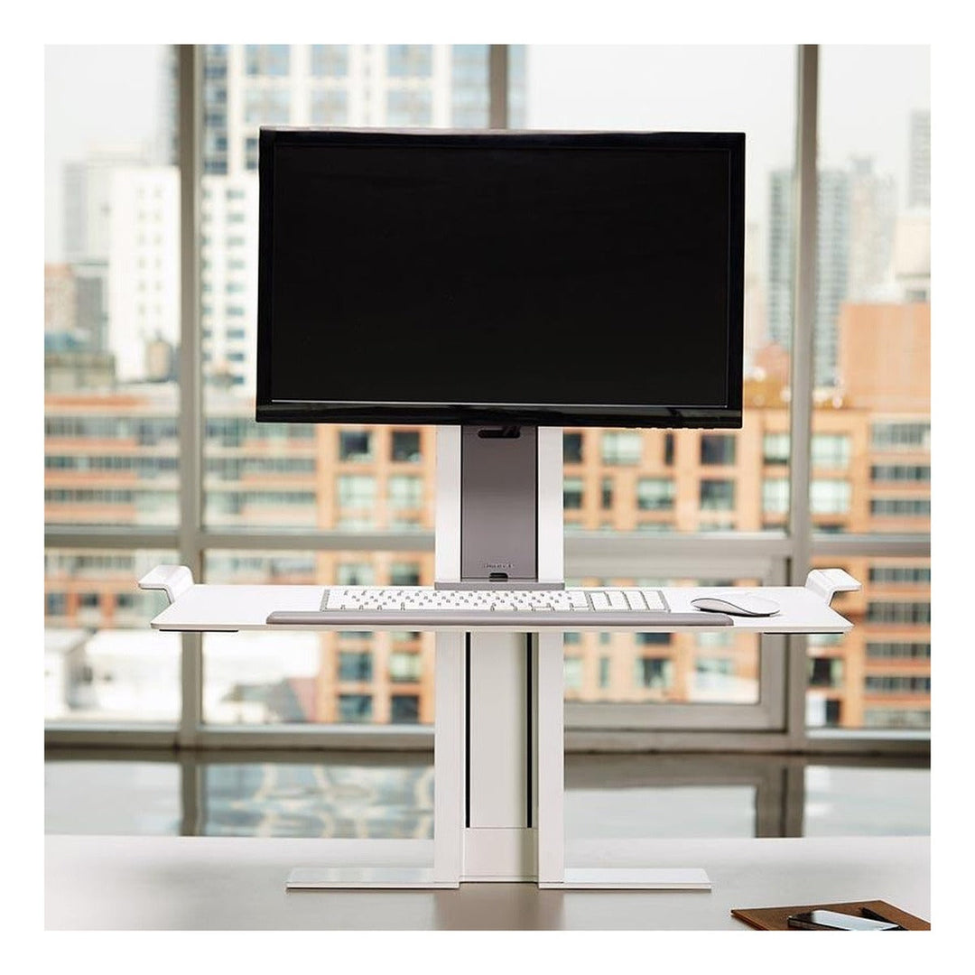Humanscale QuickStand sit-stand workstation with crossbar and keyboard platform, front view, white background (Humanscale photograph)