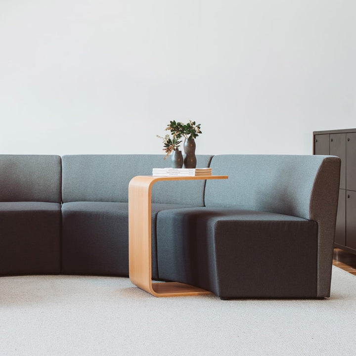 Konfurb Link table in Natural upright beside modular lounge seating