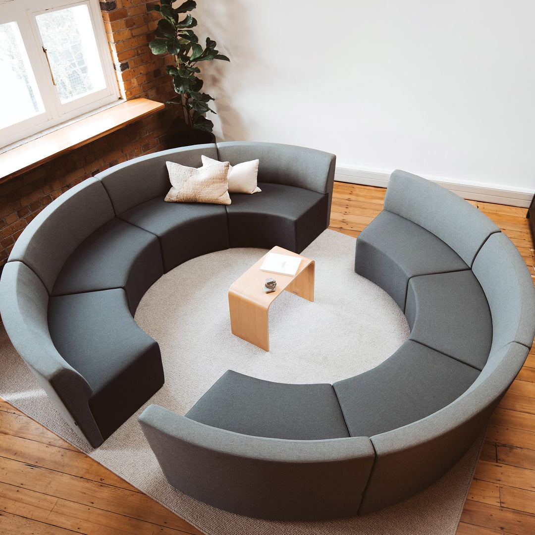 Konfurb Link table in Natural used as a coffee table inside a circular breakout seating area