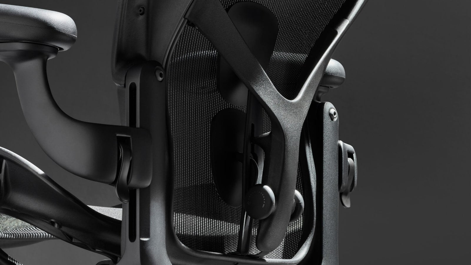 Herman Miller Aeron Remastered chair shown in Graphite in a workspace