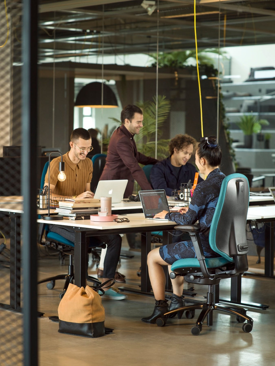 RH Mereo office chairs in teal at a shared desk in an open-plan office, four people working - Flokk photography, Chair Dinkum Australia
