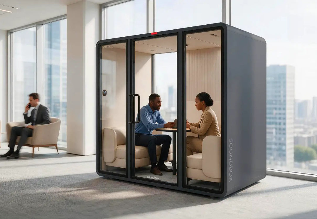 Two people meeting inside a charcoal SoundBox VRT L pod while a colleague works outside - Chair Dinkum Australia
