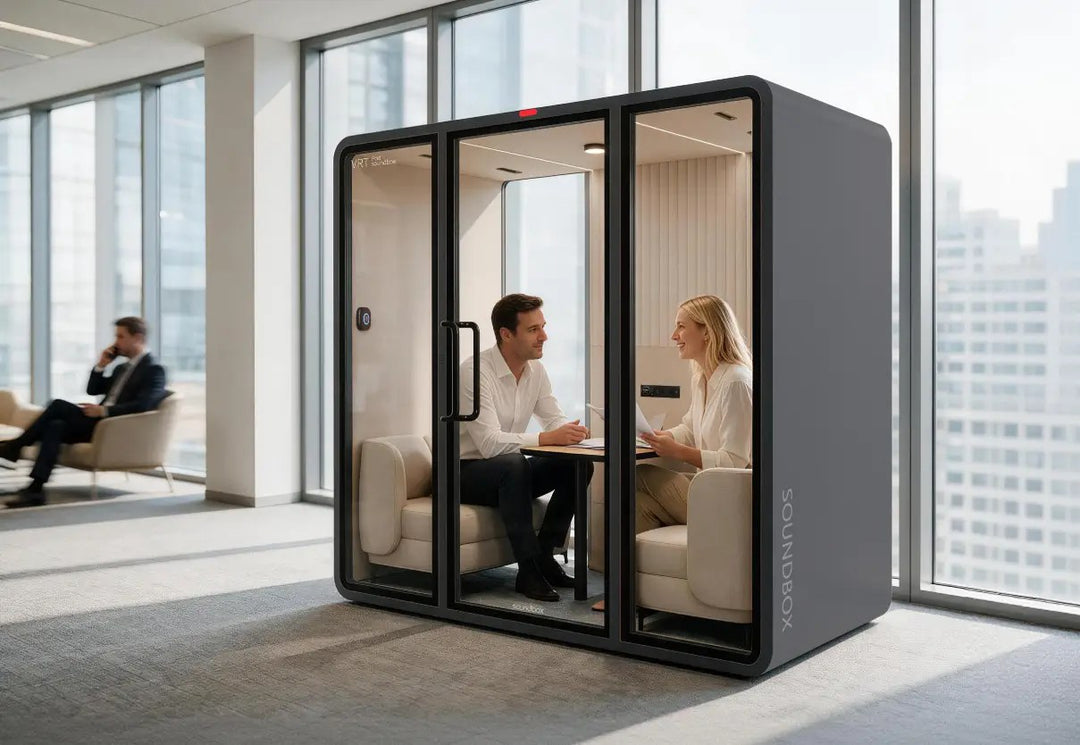 Two people meeting at the table inside a charcoal SoundBox VRT ML pod in an office - Chair Dinkum Australia