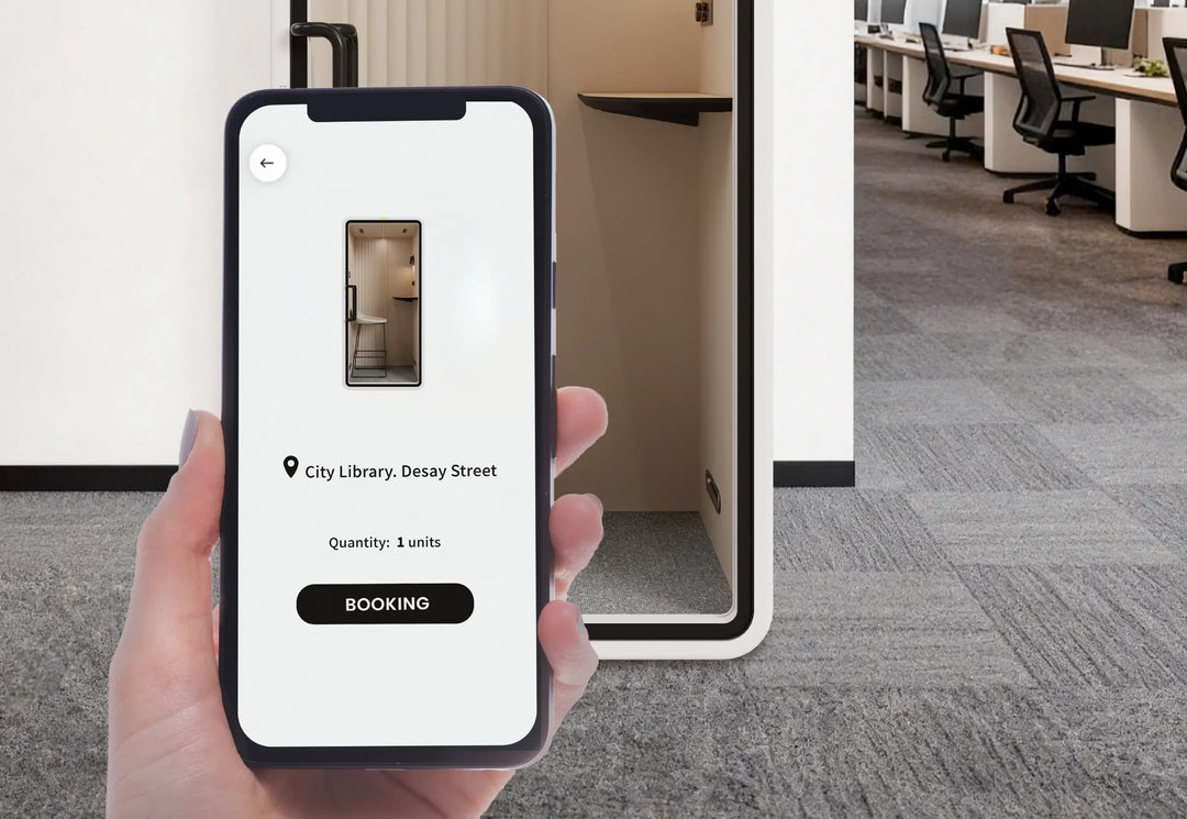 Phone showing the SoundBox app booking screen in front of a VRT S phone booth - Chair Dinkum Australia