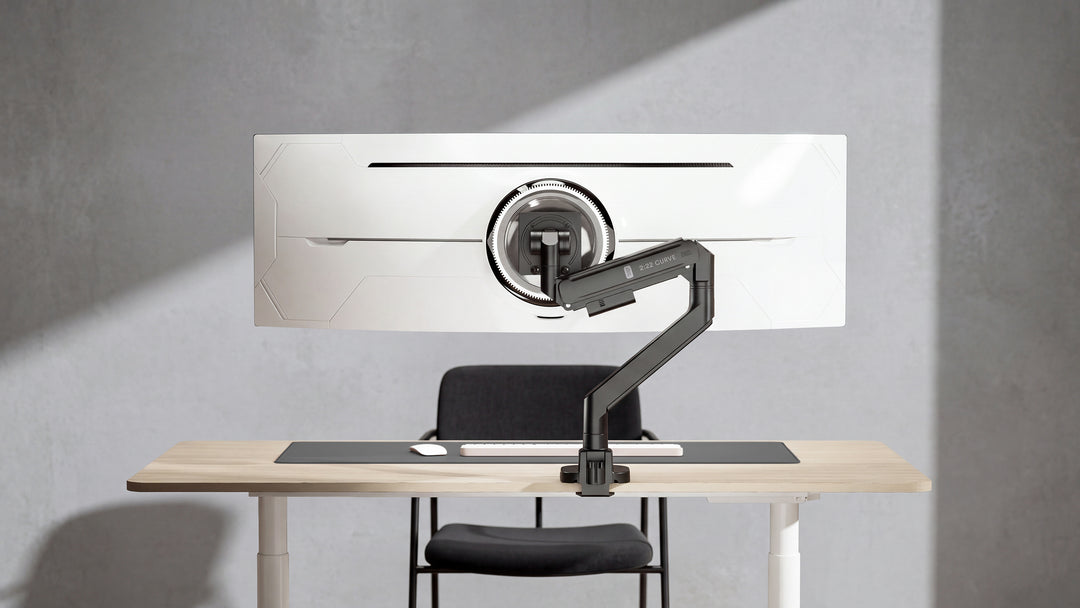 Rear view of a Thinking Works 2:22 Curve monitor arm holding a large curved screen on a desk