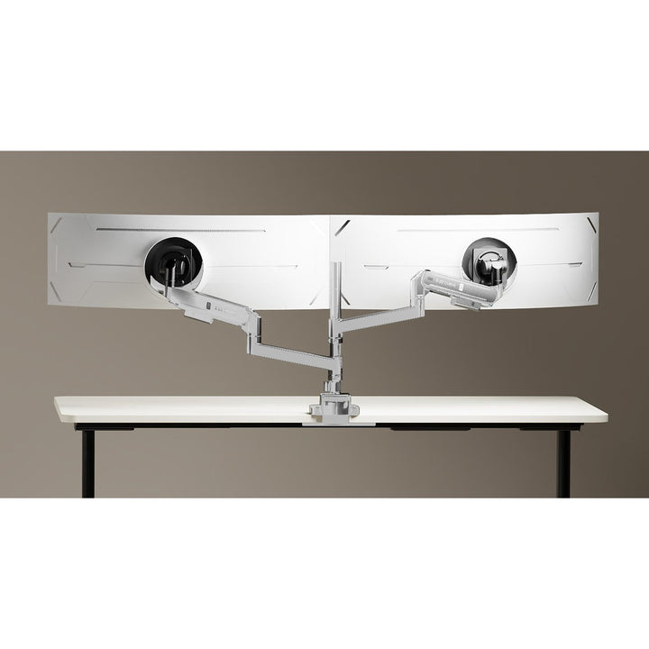 Two Thinking Works 2:22 Curve monitor arms in white on a shared desk pole, each holding a curved screen side by side above a white height-adjustable desk