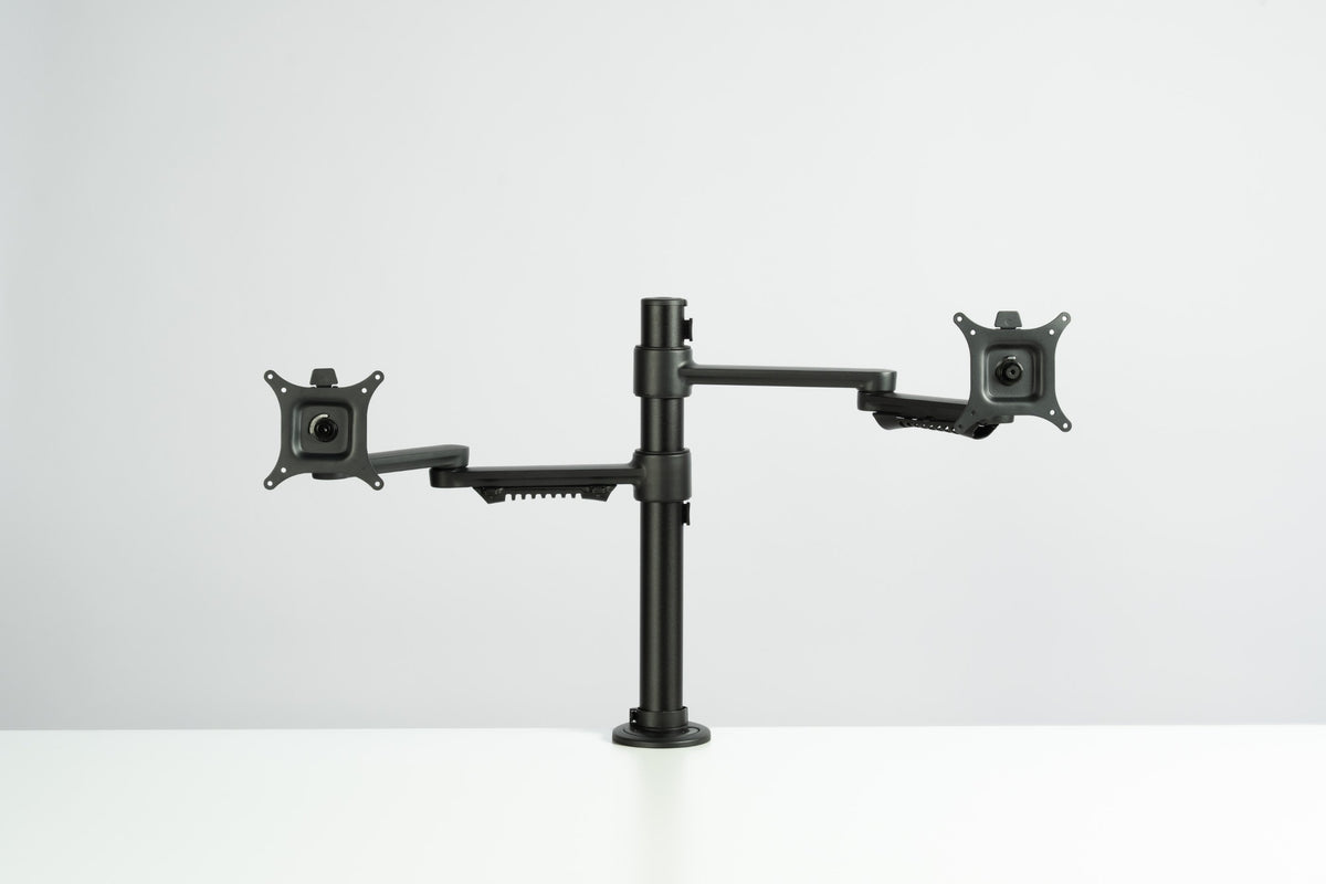 Two Thinking Works C.ME monitor arms in matte black carrying two screens at a desk (Thinking Works photograph)