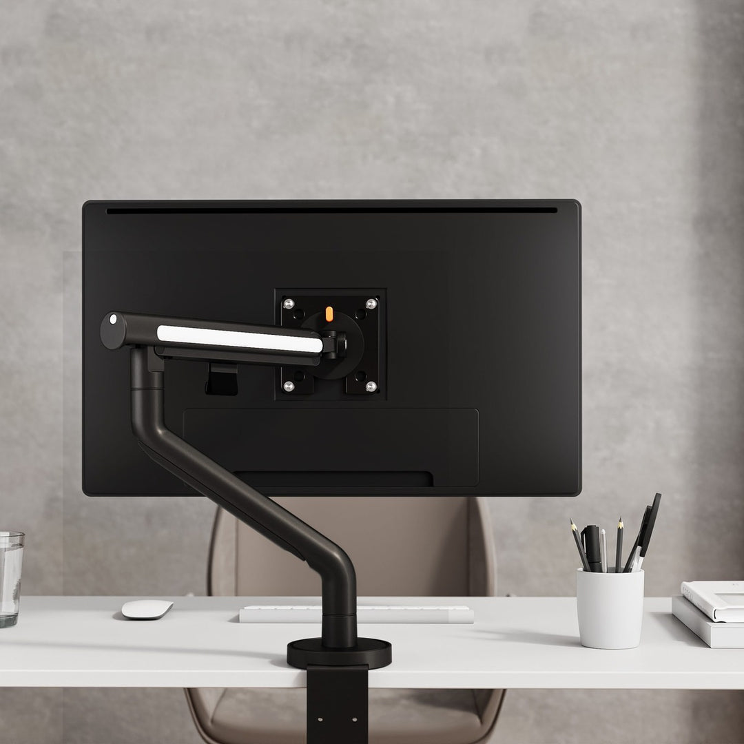 Thinking Works Glider single monitor arm holding a screen on a desk, front view