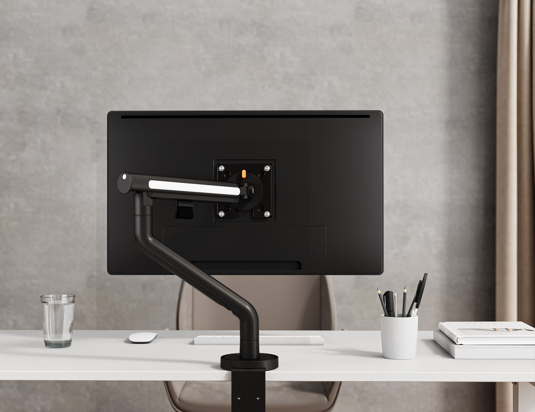 Thinking Works Glider single monitor arm holding a screen on a desk, front view