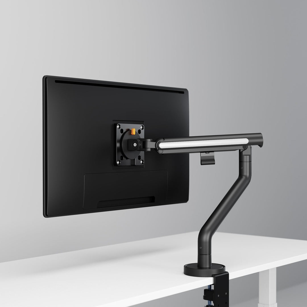 Thinking Works Glider single monitor arm in Noir Black on a desk, screen in landscape