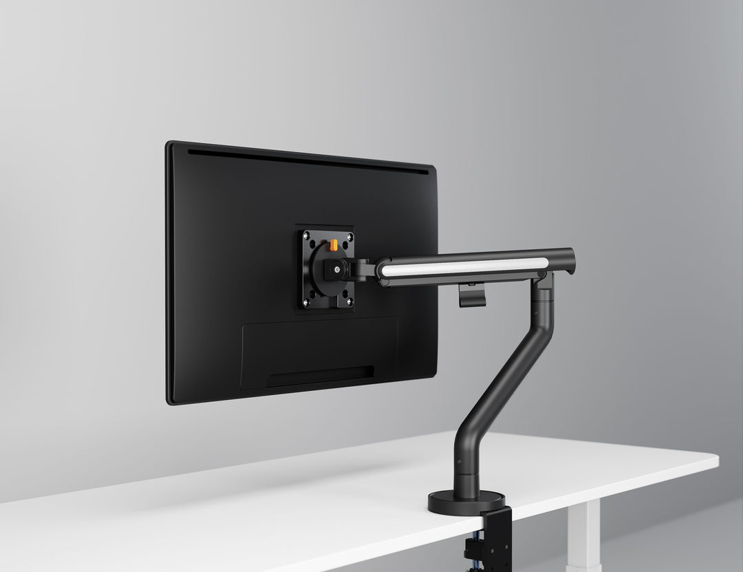 Thinking Works Glider single monitor arm in satin black on a desk, screen in landscape