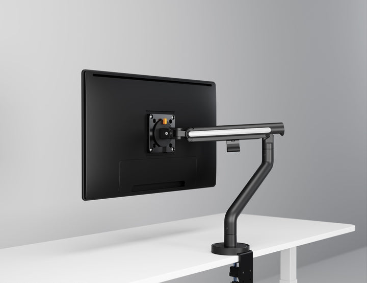 Thinking Works Glider single monitor arm in satin black on a desk, screen in landscape