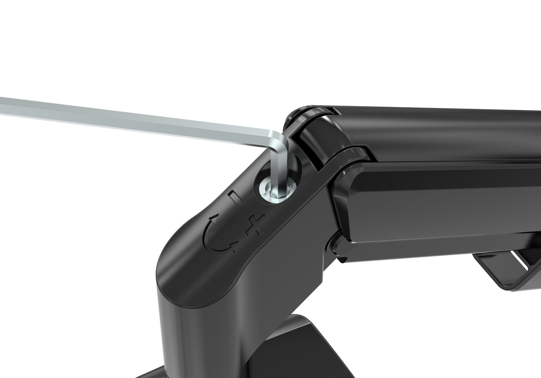 Close-up of a gloss black Thinking Works Vader arm joint with a hex key inserted into a recessed tension screw marked with plus, minus and rotation symbols.